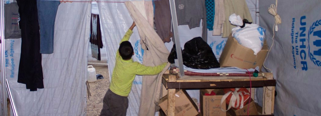 Umm ʿAbdu’s son, ʿAbdu, in the family’s tent in government-controlled Tartus. (Ghenwa Yusuf/Good Morning Syria)