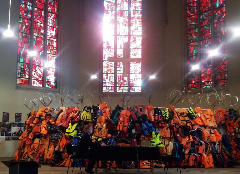The exhibit A Wall of Life Jackets and Their Stories, which collected lifejackets left behind by refugees who reached Greece. The 10-meter-long wall was on display at a Lutheran church in Saarbrucken from mid-July to the end of August. (Sandra Prufer)