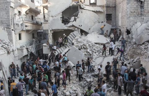 People gather at the scene after Syrian government forces allegedly dropped barrel bombs on the northern Syrian city of Aleppo, on May 30, 2015