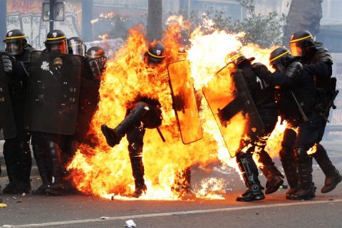 Image:  Image: French CRS anti-riot police officers are engulfed in flames